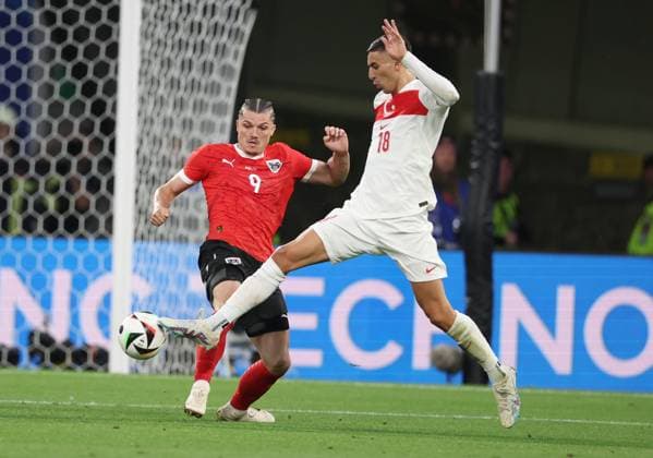 Leipzig, Germany, 2nd July 2024. Marcel Sabitzer of Austria (L) challenges Mert Muldur of Turkey during the UEFA European Championships Round of 16 match at Leipzig Stadium, Leipzig. Picture credit should read: Paul Terry Sportimage EDITORIAL USE ONLY. No use with unauthorised audio, video, data, fixture lists, club league logos or live services. Online in-match use limited to 120 images, no video emulation. No use in betting, games or single club league player publications. SPI-3215-0038