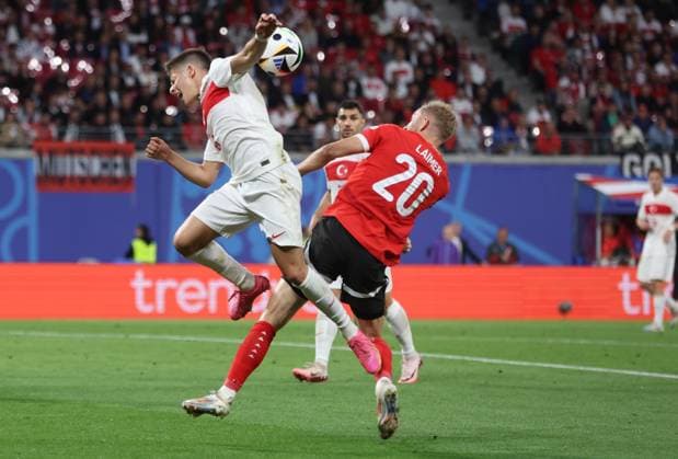 Leipzig, Germany, 2nd July 2024. Konrad Laimer of Austria (R) claims his header is handled by Arda Guler of Turkey during the UEFA European Championships Round of 16 match at Leipzig Stadium, Leipzig. Picture credit should read: Paul Terry Sportimage EDITORIAL USE ONLY. No use with unauthorised audio, video, data, fixture lists, club league logos or live services. Online in-match use limited to 120 images, no video emulation. No use in betting, games or single club league player publications. SPI-3215-0047
