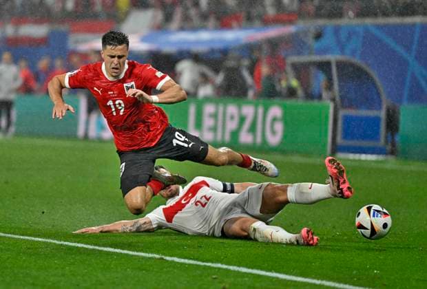 02 07 2024, Football UEFA EURO 2024, Round of 16, Austria Turkey, in the RB Arena Leipzig, Kaan Ayhan Turkey takes Christoph Baumgartner Austria off his feet