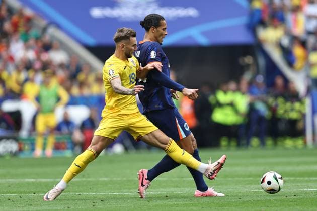 Virgil van Dijk (Netherlands)Denis Dragus (Romania) during the UEFA EURO, EM, Europameisterschaft,Fussball Germany 2024 match between Romania 0-3 Netherlands at Munich Football Arena on July 02, 2024 in Munich , Germany. Noxthirdxpartyxsales  (258440240)