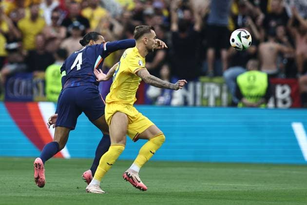 Virgil van Dijk (Netherlands) Denis Dragus (Romania) during the UEFA EURO, EM, Europameisterschaft,Fussball Germany 2024 match between Romania 0-3 Netherlands at Munich Football Arena on July 02, 2024 in Munich , Germany. Noxthirdxpartyxsales  (258440358)