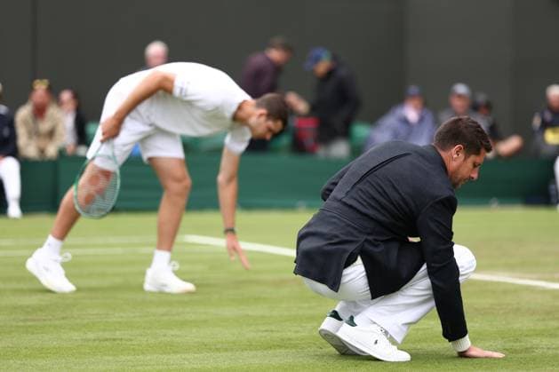 2nd July 2024; All England Lawn Tennis and Croquet Club, London, England; Wimbledon Tennis Tournament, Day 2; The referee checks how wet the court is  ActionPlus12663083 ShaunxBrooks
