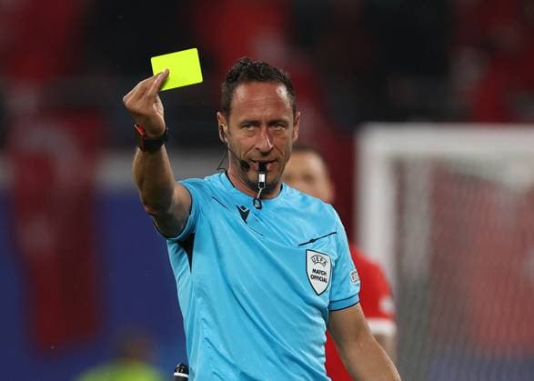 Leipzig, Germany, 2nd July 2024. Referee Artur Soares Dias holds up a yellow card during the UEFA European Championships Round of 16 match at Leipzig Stadium, Leipzig. Picture credit should read: Paul Terry Sportimage EDITORIAL USE ONLY. No use with unauthorised audio, video, data, fixture lists, club league logos or live services. Online in-match use limited to 120 images, no video emulation. No use in betting, games or single club league player publications. SPI-3215-0135