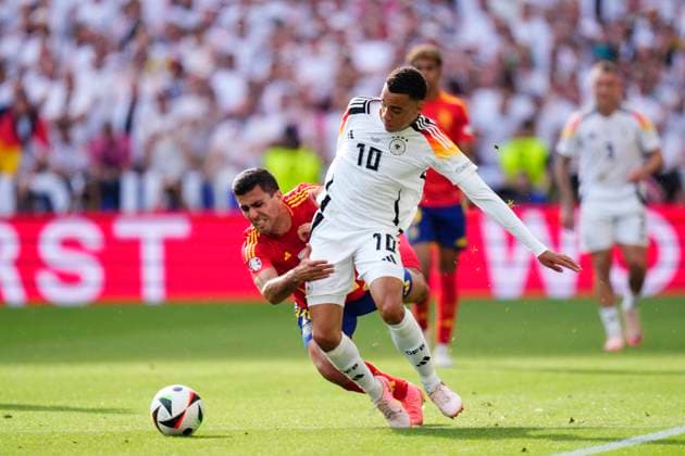 Spain v Germany: Quarter-Final - UEFA EURO, EM, Europameisterschaft,Fussball 2024 Jamal Musiala attacking midfield of Germany and Bayern Munich and Rodrigo Hernandez defensive midfield of Spain and Manchester City compete for the ball during the UEFA EURO 2024 quarter-final match between Spain and Germany at Stuttgart Arena on July 5, 2024 in Stuttgart, Germany. Stuttgart Germany  Copyright: xJosexBretonx originalFilename:bretonhernandez-spainvge240705_npOP5.jpg