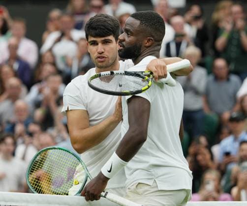Lawn Tennis - 2024 Wimbledon Championship Mens singles Carlos Alcaraz (ESP) v Frances Tiafoe (USA) All England Lawn Tennis & Croquet Club - Friday 5th July 2024 Carlos Alcaraz (ESP) consols Tiafoe at the net after the match 