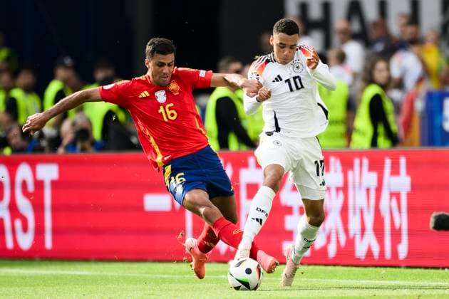 Spain v Germany - UEFA EURO, EM, Europameisterschaft,Fussball 2024 Jamal Musiala of Germany competes for the ball with Rodri of Spain during the UEFA EURO 2024 quarter-final football match between Spain and Germany. Stuttgart Germany Copyright: xNicolòxCampox