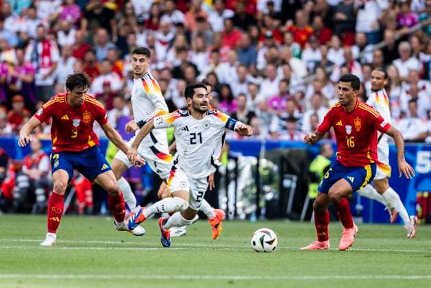 Stuttgart, MHPArena 05 07 2024 Robin Le Normand of spain L and Rodri of spain challenge Ilkay Guendogan of germany during the quarterfinal match Spain v Germany at the UEFA European Championship 2024