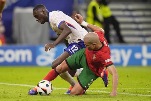 Randal Kolo Muani of France battle for a ball with Portugal s Pepe during a quarterfinal match between Portugal and France at the Euro 2024 soccer tournament in Hamburg, Germany - Friday July 5, 2024. - Soccer .  Copyright: xFabioxFerrari LaPressex