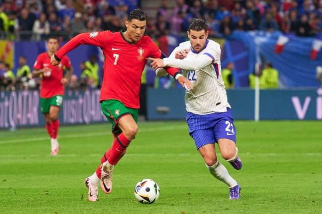 Cristiano Ronaldo of Portugal fights for the ball withTheo Hernandez of France during the UEFA EURO, EM, Europameisterschaft,Fussball 2024 quarter finals match between France and Portugal at Volksparkstadion on July 5, 2024 in Hamburg Germany (Photo by Camilla Stolen Imago) Hamburg Germany Copyright: xCamillaxStolenx L2160179