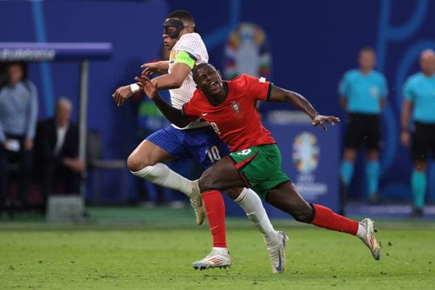 Hamburg, Germany, 5th July 2024. Kylian Mbappe of France clashes with Nuno Mendes of Portugal during the UEFA European Championships quarter final match at Volksparkstadion, Hamburg. Picture credit should read: Jonathan Moscrop Sportimage EDITORIAL USE ONLY. No use with unauthorised audio, video, data, fixture lists, club league logos or live services. Online in-match use limited to 120 images, no video emulation. No use in betting, games or single club league player publications. SPI-3219-0008