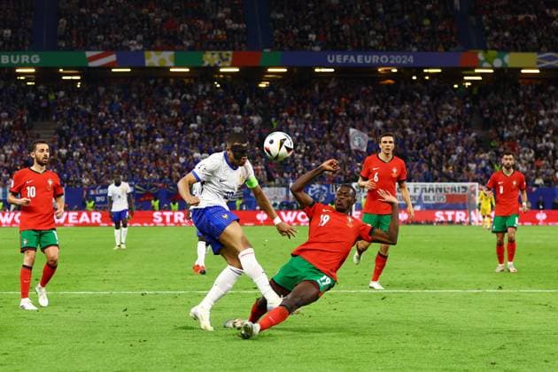 Nuno Mendes of Portugal blocks a shot from Kylian Mbappà of France Portugal v France, UEFA European Championship, EM, Europameisterschaft 2024, Quarter Final, Football, Volksparkstadion, Hamburg, Germany, 05 Jul 2024 EDITORIAL USE ONLY No use with unauthorised audio, video, data, fixture lists, club league logos or live services. Online in-match use limited to 120 images, no video emulation. No use in betting, games or single club league player publications. Copyright: xKieranxMcManus Shutterstockx 14571382bp