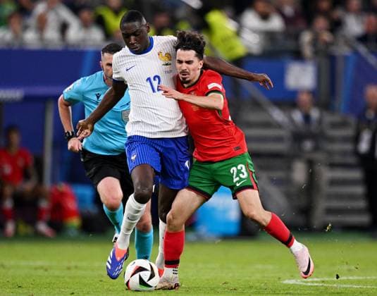 Russia Soccer Euro 2024 Portugal - France 8723220 05.07.2024 France s Randal Kolo Muani and Portugal s Vitinha struggle for the ball during the UEFA EURO, EM, Europameisterschaft,Fussball 2024 quarter final soccer match between Portugal and France at the Volksparkstadion in Hamburg, Germany. Alexey Filippov Sputnik Hamburg Germany  Copyright: xAlexeyxFilippovx