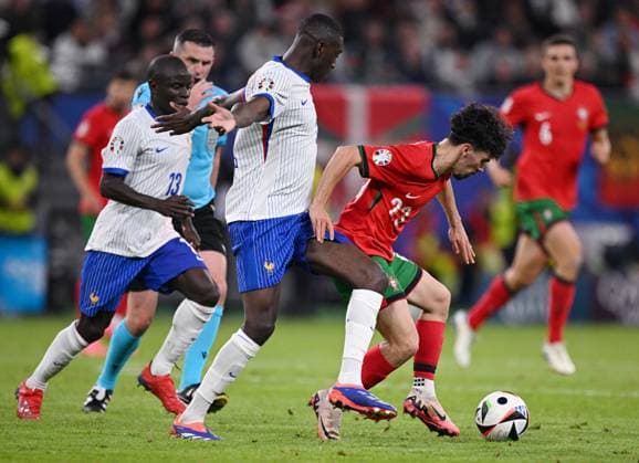 Russia Soccer Euro 2024 Portugal - France 8723221 05.07.2024 France s N Golo Kante, France s Randal Kolo Muani and Portugal s Vitinha struggle for the ball during the UEFA EURO, EM, Europameisterschaft,Fussball 2024 quarter final soccer match between Portugal and France at the Volksparkstadion in Hamburg, Germany. Alexey Filippov Sputnik Hamburg Germany  Copyright: xAlexeyxFilippovx