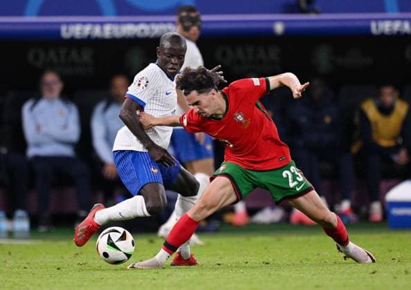 Russia Soccer Euro 2024 Portugal - France 8723224 05.07.2024 France s N Golo Kante and Portugal s Vitinha struggle for the ball during the UEFA EURO, EM, Europameisterschaft,Fussball 2024 quarter final soccer match between Portugal and France at the Volksparkstadion in Hamburg, Germany. Alexey Filippov Sputnik Hamburg Germany  Copyright: xAlexeyxFilippovx