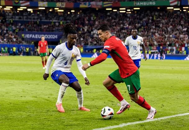 5th July 2024; Volksparkstadion, Hamburg, Germany; Euro 2024 Quarter Final Football, Portugal versus France; Eduardo Camavinga (FRA) is taken on by Cristiano Ronaldo (POR) in the penalty box  ActionPlus12664431 FotoxOlimpik