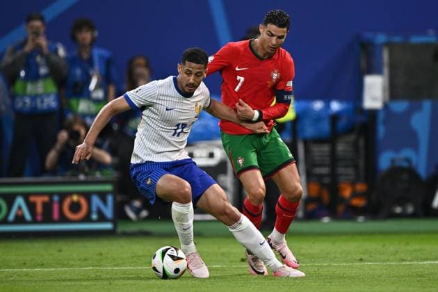 HAMBURG, GERMANY - JULY 5: William Saliba of France and Cristiano Ronaldo of Portugal battle for the ball during the UEFA EURO, EM, Europameisterschaft,Fussball 2024 quarter-final match between Portugal and France at Volksparkstadion on July 5, 2024 in Hamburg, G Portugal v France: Quarter-Final - UEFA EURO 2024 Copyright: xSebastianxFrejx