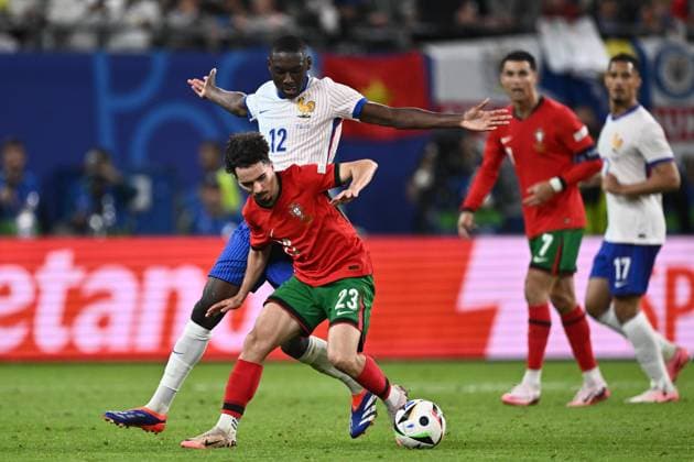 HAMBURG, GERMANY - JULY 5: Randal Kolo Muani of France and Vitinha of Portugal battle for the ball during the UEFA EURO, EM, Europameisterschaft,Fussball 2024 quarter-final match between Portugal and France at Volksparkstadion on July 5, 2024 in Hamburg, G Portugal v France: Quarter-Final - UEFA EURO 2024 Copyright: xSebastianxFrejx
