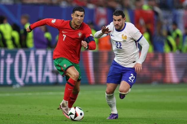 Hamburg, Germany, 5th July 2024. Cristiano Ronaldo of Portugal and Theo Hernandez of France during the UEFA European Championships Quarter Final match at Volksparkstadion, Hamburg. Picture credit should read: Paul Terry Sportimage EDITORIAL USE ONLY. No use with unauthorised audio, video, data, fixture lists, club league logos or live services. Online in-match use limited to 120 images, no video emulation. No use in betting, games or single club league player publications. SPI-3217-0100