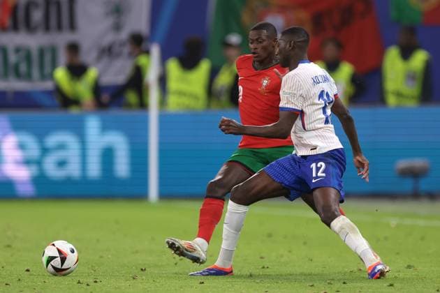 Hamburg, Germany, 5th July 2024. Randal Kolo Muani of France challenges Nuno Mendes of Portugal during the UEFA European Championships quarter final match at Volksparkstadion, Hamburg. Picture credit should read: Jonathan Moscrop Sportimage EDITORIAL USE ONLY. No use with unauthorised audio, video, data, fixture lists, club league logos or live services. Online in-match use limited to 120 images, no video emulation. No use in betting, games or single club league player publications. SPI-3219-0037