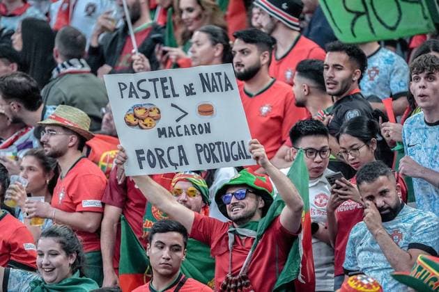 EURO 2024 - Quarter-Finals: Portugal vs. France Portugal fans join the food wars with a Pastel de Nata > Macaron sign during the EURO 2024 Quarter-Final match between Portugal and France on 05 July 2024, at Volksparkstadion, in Hamburg, Germany Hamburg Volksparkstadion Germany Copyright: xAlexandraxFechetex DSC03993