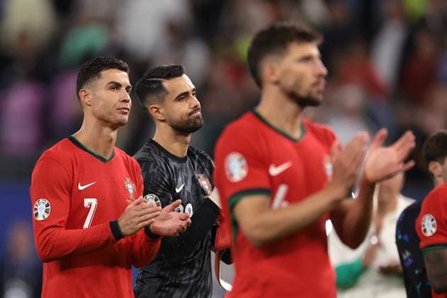 Hamburg, Germany, 5th July 2024. Cristiano Ronaldo of Portugal applauds the fans along with team mates Diogo Costa and Ruben Dias followng the defeat in the penalty shoot out of the UEFA European Championships quarter final match at Volksparkstadion, Hamburg. Picture credit should read: Jonathan Moscrop Sportimage EDITORIAL USE ONLY. No use with unauthorised audio, video, data, fixture lists, club league logos or live services. Online in-match use limited to 120 images, no video emulation. No use in betting, games or single club league player publications. SPI-3219-0090