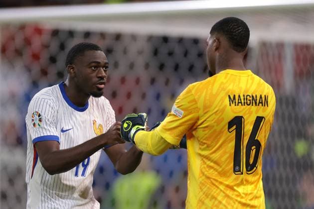 Hamburg, Germany, 5th July 2024. Youssouf Fofana of France celebrates with team mate Mike Maignan after successfully converting his penalty during the shoot out in the UEFA European Championships quarter final match at Volksparkstadion, Hamburg. Picture credit should read: Jonathan Moscrop Sportimage EDITORIAL USE ONLY. No use with unauthorised audio, video, data, fixture lists, club league logos or live services. Online in-match use limited to 120 images, no video emulation. No use in betting, games or single club league player publications. SPI-3219-0101