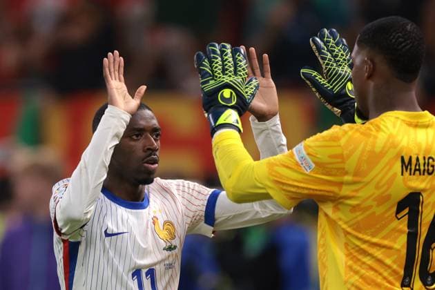Hamburg, Germany, 5th July 2024. Ousmane Dembele of France celebrtaes with team mate Mike Maignan after scoring his penalty in the shoot out in the UEFA European Championships quarter final match at Volksparkstadion, Hamburg. Picture credit should read: Jonathan Moscrop Sportimage EDITORIAL USE ONLY. No use with unauthorised audio, video, data, fixture lists, club league logos or live services. Online in-match use limited to 120 images, no video emulation. No use in betting, games or single club league player publications. SPI-3219-0117