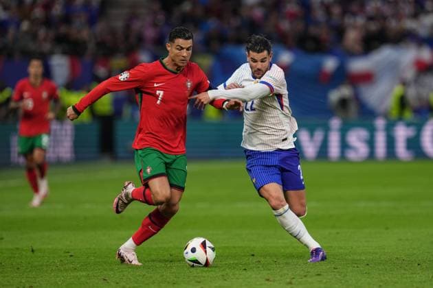 (240706) -- HAMBURG, July 6, 2024 -- Cristiano Ronaldo (L) of Portugal vies with Theo Hernandez of France during the UEFA EURO, EM, Europameisterschaft,Fussball 2024 quarter-final match between Portugal and France in Hamburg, Germany on July 5, 2024. ) (SP)GERMANY-HAMBURG-FOOTBALL-EURO 2024-QUARTER FINAL-PORTUGAL VS FRANCE PengxZiyang 