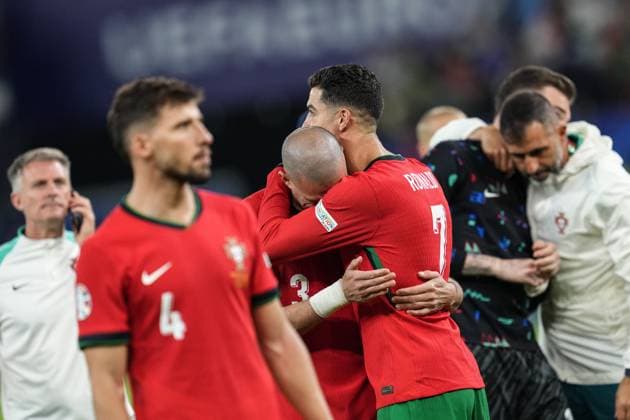 (240706) -- HAMBURG, July 6, 2024 -- Cristiano Ronaldo (3rd R) of Portugal comforts Pepe after the UEFA EURO, EM, Europameisterschaft,Fussball 2024 quarter-final match between Portugal and France in Hamburg, Germany on July 5, 2024. ) (SP)GERMANY-HAMBURG-FOOTBALL-EURO 2024-QUARTER FINAL-PORTUGAL VS FRANCE PanxYulong 
