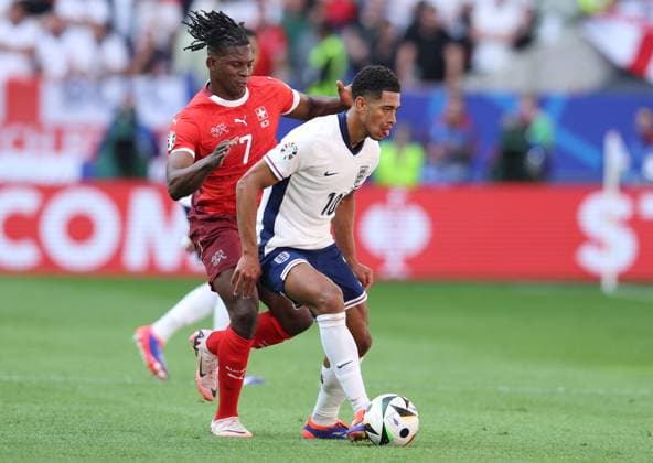Dusseldorf, Germany, 6th July 2024. Jude Bellingham of England (R) is challenged by Breel Embolo of Switzerland during the UEFA European Championships Quarter Final match at Dusseldorf Arena, Dusseldorf. Picture credit should read: Paul Terry Sportimage EDITORIAL USE ONLY. No use with unauthorised audio, video, data, fixture lists, club league logos or live services. Online in-match use limited to 120 images, no video emulation. No use in betting, games or single club league player publications. SPI-3218-0035