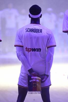 International match between Germany and France in the Lanxess Arena Cologne Preparation for the Summer Olympics Here Dennis Schröder with the German flag during the national anthem before the match