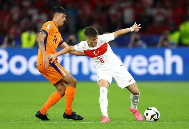 Tijjani Reijnders of Netherlands and Arda Güler of Türkiye Netherlands v Turkiye, UEFA European Championship, EM, Europameisterschaft 2024, Quarter Final, Football, Olympiastadion, Berlin, Germany, 06 Jul 2024 EDITORIAL USE ONLY No use with unauthorised audio, video, data, fixture lists, club league logos or live services. Online in-match use limited to 120 images, no video emulation. No use in betting, games or single club league player publications.  Copyright: xKieranxMcManus Shutterstockx 14571393be