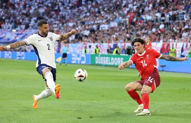 Dusseldorf, Germany, 6th July 2024. Steven Zuber of Switzerland attempts a cross past Kyle Walker of England during the UEFA European Championships Quarter Final match at Dusseldorf Arena, Dusseldorf. Picture credit should read: Paul Terry Sportimage EDITORIAL USE ONLY. No use with unauthorised audio, video, data, fixture lists, club league logos or live services. Online in-match use limited to 120 images, no video emulation. No use in betting, games or single club league player publications. SPI-3218-0228