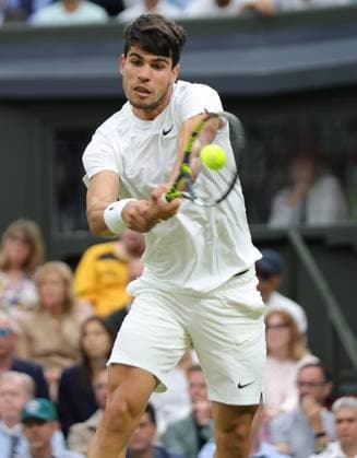 Spain s Carlos Alcaraz plays a backhand in his match against France s Ugo Humbert on day seven of the 2024 Wimbledon Championships in London on Sunday, July 07, 2024.  LON2024070710 HUGOxPHILPOTT