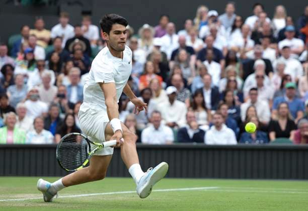 (240708) -- LONDON, July 8, 2024 -- Carlos Alcaraz hits a return during the men s singles 4th round match between Ugo Humbert of France and Carlos Alcaraz of Spain at Wimbledon tennis Championship in London, Britain, on July 7, 2024. ) (SP)BRITAIN-LONDON-TENNIS-WIMBLEDON-DAY 7 HanxYan 