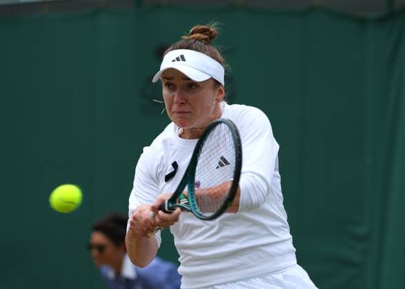 8th July 2024; All England Lawn Tennis and Croquet Club, London, England; Wimbledon Tennis Tournament, Day 8; Elina Svitolina (UKR) with a backhand shot to Wang Xinyu (CHN), ladies singles match while wearing a black ribbon in support of the victims of the Russia-Ukraine war  ActionPlus12666256 JohnxPatrickxFletcher
