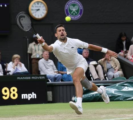 Serbian Novak Djokovic plays a forehand in his fourth round match against Norway s Holger Rune at the 2024 Wimbledon Championships in London on Monday, July 08, 2024.  LON20240708101 HUGOxPHILPOTT
