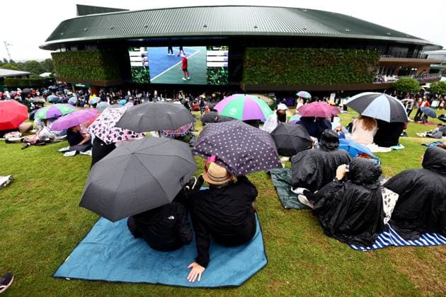 Spectators shelter under umbrellas around the grounds as rain falls before the start of play. Wimbledon Tennis Championships, Day 9, The All England Lawn Tennis and Croquet Club, London, UK - 09 Jul 2024  Copyright: xJamesxMarsh Shutterstockx 14577170i