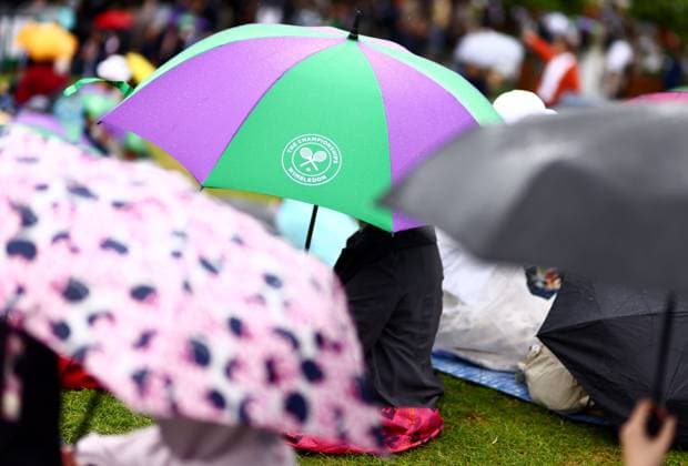 Spectators shelter under umbrellas around the grounds as rain falls before the start of play. Wimbledon Tennis Championships, Day 9, The All England Lawn Tennis and Croquet Club, London, UK - 09 Jul 2024  Copyright: xJamesxMarsh Shutterstockx 14577170e