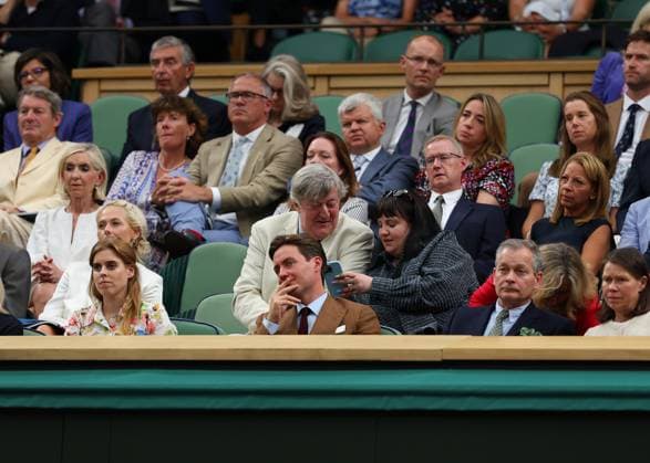 9th July 2024; All England Lawn Tennis and Croquet Club, London, England; Wimbledon Tennis Tournament, Day 9; English actor, broadcaster and comedian Stephen Fry sitting next to a friend checking on a smartphone at the Royal Box inside Centre Court sitting behind Princess Beatrice  ActionPlus12666391 JohnxPatrickxFletcher