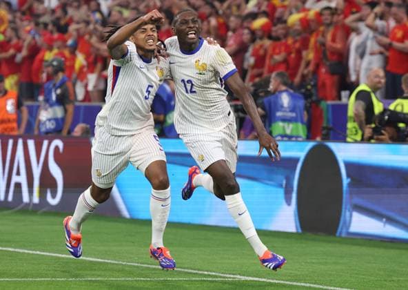 Munich, Germany, 9th July 2024. Randal Kolo Muani of France (R) celebrates after scoring the opening goal with Jules Kounde of France during the UEFA European Championships semi final match at Allianz Arena, Munich. Picture credit should read: Paul Terry Sportimage EDITORIAL USE ONLY. No use with unauthorised audio, video, data, fixture lists, club league logos or live services. Online in-match use limited to 120 images, no video emulation. No use in betting, games or single club league player publications. SPI-3225-0038