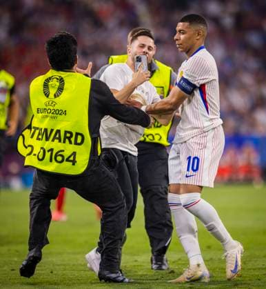Munich, Germany 09th Jul 2024 Speedster takes a selfie with Kylian Mbappe FRA and is stopped by stewards Spain France Spain France 09 07 2024