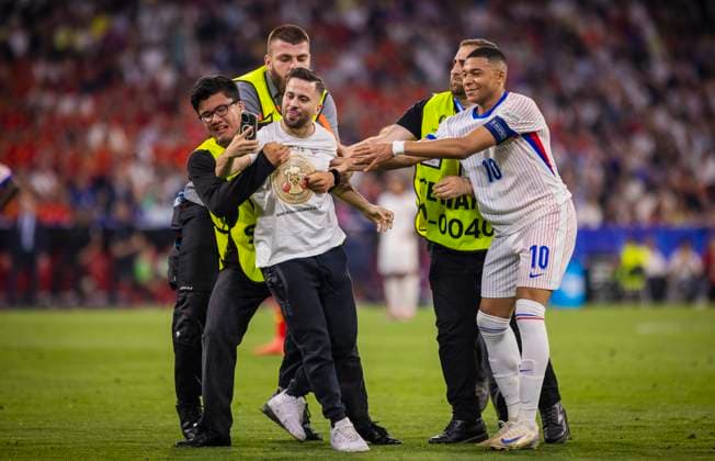 Munich, Germany 09th Jul 2024 Speedster takes a selfie with Kylian Mbappe FRA and is stopped by stewards Spain France Spain France 09 07 2024