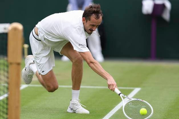 (240710) -- LONDON, July 10, 2024 -- Daniil Medvedev hits a return during the men s singles quarterfinal match between Jannik Sinner of Italy and Daniil Medvedev of Russia at Wimbledon tennis Championship in London, Britain, July 9, 2024. ) (SP)BRITAIN-LONDON-TENNIS-WIMBLEDON-DAY 9 HanxYan 