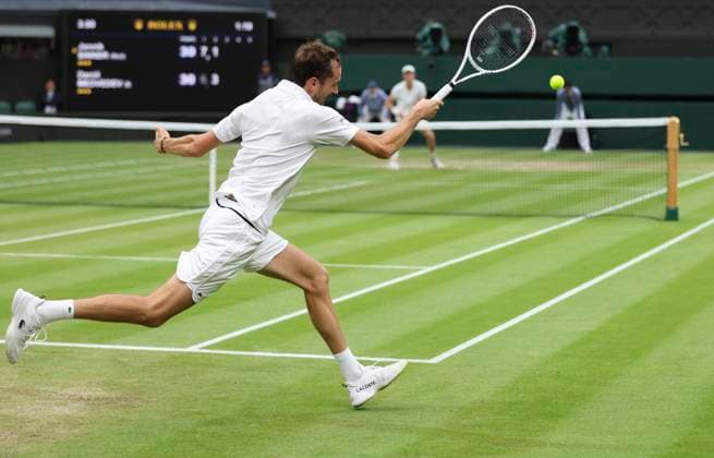 (240710) -- LONDON, July 10, 2024 -- Daniil Medvedev hits a return during the men s singles quarterfinal match between Jannik Sinner of Italy and Daniil Medvedev of Russia at Wimbledon tennis Championship in London, Britain, July 9, 2024. ) (SP)BRITAIN-LONDON-TENNIS-WIMBLEDON-DAY 9 HanxYan 