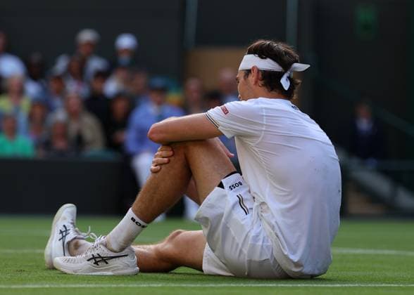10th July 2024; All England Lawn Tennis and Croquet Club, London, England; Wimbledon Tennis Tournament, Day 10; Taylor Fritz (USA) slips on the court and injures his knee at match point against Lorenzo Musetti (ITA), mens singles quarter final match  ActionPlus12666650 JohnxPatrickxFletcher