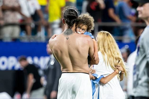 CHARLOTTE, NC - JULY 10: Uruguay forward Darwin Nunez (19) holds a young child on the pitch after the CONMEBOL Copa America semifinal between Uruguay and Colombia on Wednesday July 10, 2024 at Bank of America Stadium in Charlotte, NC. (Photo by Nick Tre. Smith Icon Sportswire) SOCCER: JUL 10 CONMEBOL Copa America - Semifinals - Uruguay vs Colombia EDITORIAL USE ONLY Icon2407100125
