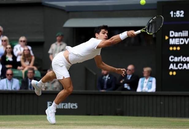 (240712) -- LONDON, July 12, 2024 -- Carlos Alcaraz of Spain hits a return during the men s singles semifinal between Daniil Medvedev of Russia and Carlos Alcaraz of Spain at Wimbledon tennis Championship in London, Britain, on July 12, 2024. ) (SP)BRITAIN-LONDON-TENNIS-WIMBLEDON--MEN S SINGLES-SEMIFINALS HanxYan 