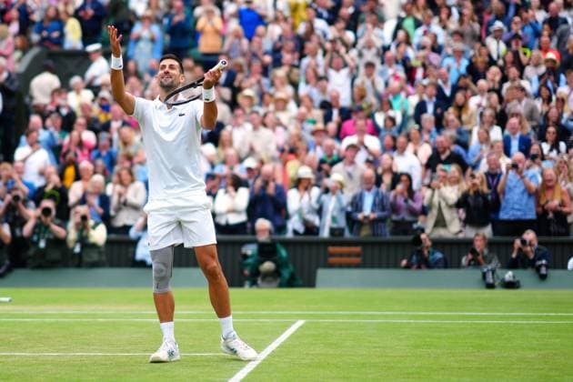 Novak Djokovic celebrates by playing the violin after winning his semi final match Wimbledon Tennis Championships, Day 12, The All England Lawn Tennis and Croquet Club, London, UK - 12 Jul 2024  Copyright: xJavierxGarcia Shutterstockx 14581882il