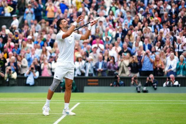 Novak Djokovic celebrates by playing the violin after winning his semi final match Wimbledon Tennis Championships, Day 12, The All England Lawn Tennis and Croquet Club, London, UK - 12 Jul 2024  Copyright: xJavierxGarcia Shutterstockx 14581882iq